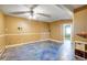 Living room with blue flooring, a ceiling fan, and access to other rooms at 33090 Janelle Cir, Golden, CO 80403