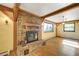 Living room with hardwood floors, a brick fireplace, and large windows at 33090 Janelle Cir, Golden, CO 80403