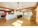 Open floor plan featuring a kitchen and living room with exposed beams and hardwood floors at 33090 Janelle Cir, Golden, CO 80403
