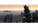 Scenic mountain view with snow-covered trees and a stunning sunrise in the background at 33090 Janelle Cir, Golden, CO 80403