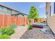 A serene backyard with rock landscaping and a wooden fence, ideal for relaxation at 12513 Grape St, Thornton, CO 80241
