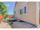 Exterior of home with patio, gravel landscaping, and wooden fence at 12513 Grape St, Thornton, CO 80241