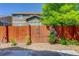 A backyard view with a wooden fence accented with flowering vines at 12513 Grape St, Thornton, CO 80241