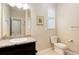 Bathroom vanity with granite countertops, a sink, and a toilet at 12513 Grape St, Thornton, CO 80241