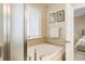 Relaxing bathroom with a large soaking tub and picture window at 12513 Grape St, Thornton, CO 80241