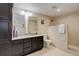 Modern bathroom featuring granite countertops, double sinks, and a tiled shower at 12513 Grape St, Thornton, CO 80241