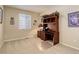 Neutral-toned bedroom featuring carpet, a window, and built-in shelving unit at 12513 Grape St, Thornton, CO 80241