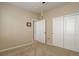 Bedroom with carpeted floors, white trim, and a closet with sliding doors at 12513 Grape St, Thornton, CO 80241