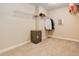 Walk-in closet with neutral carpeting, shelving for storage and hanging clothes at 12513 Grape St, Thornton, CO 80241