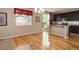 Bright dining area with hardwood floors, adjacent to the kitchen and featuring a sliding glass door at 12513 Grape St, Thornton, CO 80241