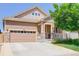 Inviting two-story home featuring a two-car garage, charming porch, and well-maintained lawn at 12513 Grape St, Thornton, CO 80241
