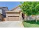 Charming two-story home showcasing a well-maintained yard and inviting front porch at 12513 Grape St, Thornton, CO 80241