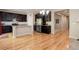 Spacious kitchen featuring stainless steel appliances, granite countertops, dark cabinets, and hardwood floors at 12513 Grape St, Thornton, CO 80241
