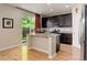 Stylish kitchen with stainless steel appliances, granite countertops, and dark wood cabinetry at 12513 Grape St, Thornton, CO 80241