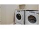 Laundry room features white front loading washer and dryer at 12513 Grape St, Thornton, CO 80241