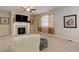 Cozy living room featuring a fireplace, neutral carpet, and large window for natural light at 12513 Grape St, Thornton, CO 80241