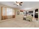 Open concept living room and kitchen with carpet, natural light, and neutral color scheme at 12513 Grape St, Thornton, CO 80241