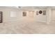 Spacious living room featuring neutral carpet, recessed lighting, and ample natural light at 12513 Grape St, Thornton, CO 80241
