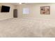 Bright living room with plush carpet, a ceiling fan, large window, and a wall-mounted TV at 12513 Grape St, Thornton, CO 80241