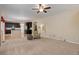 Spacious living room with carpet, fireplace, open to kitchen, and neutral color scheme at 12513 Grape St, Thornton, CO 80241