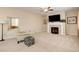 Bright living room with fireplace, carpet, and comfortable seating at 12513 Grape St, Thornton, CO 80241