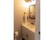 Cozy half-bathroom with modern mirror, stylish faucet, and storage beneath the white sink at 19738 Applewood Ct, Parker, CO 80138