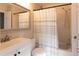 Bright bathroom featuring a white vanity and a shower with a striped curtain at 19738 Applewood Ct, Parker, CO 80138
