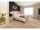 Inviting bedroom with a striking dark accent wall and bright white bedding at 19738 Applewood Ct, Parker, CO 80138