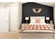 Bright bedroom with an accent wall and a bed with a white frame and two bedside tables at 19738 Applewood Ct, Parker, CO 80138