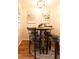 Charming dining area with a round table, bar stools, and artistic wall decor at 19738 Applewood Ct, Parker, CO 80138