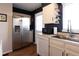 The kitchen has wooden floors, white cabinets and appliances, and a stainless steel refrigerator at 19738 Applewood Ct, Parker, CO 80138