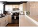 Bright kitchen features white cabinets, stainless steel appliances, and a breakfast bar at 19738 Applewood Ct, Parker, CO 80138