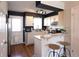 Well-lit kitchen featuring wooden floors, white cabinets, and a breakfast bar with barstool seating at 19738 Applewood Ct, Parker, CO 80138