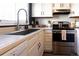 Bright kitchen showcasing stainless steel appliances, white cabinets, and a large stainless steel sink at 19738 Applewood Ct, Parker, CO 80138