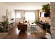 Warm living room with hardwood floors, stylish furnishings, and plenty of natural light at 19738 Applewood Ct, Parker, CO 80138