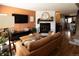 Inviting living room featuring a brick fireplace, hardwood floors, and stylish decor at 19738 Applewood Ct, Parker, CO 80138