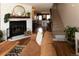 Bright living room boasts hardwood floors, a brick fireplace, and staircase access at 19738 Applewood Ct, Parker, CO 80138