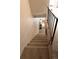 Carpeted staircase with modern metal railing at 19738 Applewood Ct, Parker, CO 80138