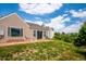 A cozy backyard with a stone patio and sliding glass door access to the home at 535 High Point Dr, Golden, CO 80403