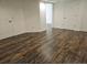 Basement area showcasing dark wood-look flooring and multiple white doors at 535 High Point Dr, Golden, CO 80403