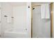 Bathroom showcasing a soaking tub, walk-in shower with gold trim, and stylish fixtures at 535 High Point Dr, Golden, CO 80403