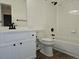 Bright bathroom featuring a vanity, bathtub with white tile surround and modern black fixtures at 535 High Point Dr, Golden, CO 80403
