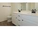Bathroom featuring dual sinks, modern fixtures, wood-look flooring, and a combined shower and bathtub at 535 High Point Dr, Golden, CO 80403