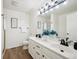 Bathroom featuring a double vanity with sleek fixtures and modern lighting at 535 High Point Dr, Golden, CO 80403