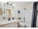 This bright bathroom features white cabinets, modern fixtures, and a shower-tub combination at 535 High Point Dr, Golden, CO 80403