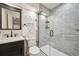 This renovated bathroom features a sleek vanity and a glass-enclosed shower at 535 High Point Dr, Golden, CO 80403