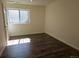 Finished basement bedroom with a window for natural light and wood-look flooring at 535 High Point Dr, Golden, CO 80403