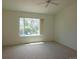 Spacious, light-filled bedroom with a large window offering views of mature trees and outdoor scenery at 535 High Point Dr, Golden, CO 80403