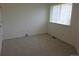Bedroom featuring neutral carpeting, a window with blinds, and an electrical outlet at 535 High Point Dr, Golden, CO 80403