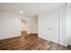Large basement bedroom with wood-look flooring and bright neutral paint at 535 High Point Dr, Golden, CO 80403